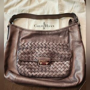 Platinum Cole Haan shoulder purse, brass details with dust bag.